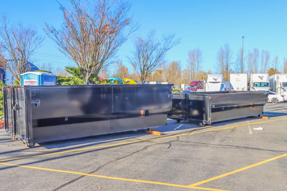 Professional dumpster rental service with roll-off container on residential driveway in St. Louis